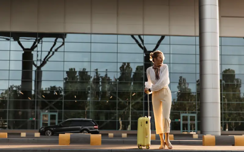 Young girl with a suitcase on arrival at the airport