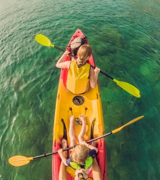 Family in a large kayak in the middle of the sea